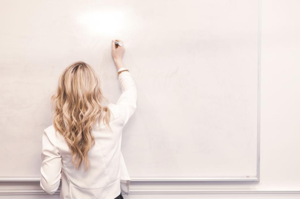Free Image of Person Writing on a Whiteboard in a Professional Setting 