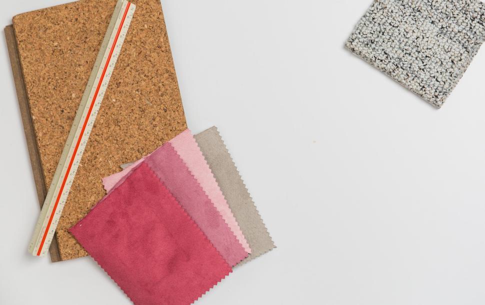 Free Image of Assorted fabric swatches, notebook, and ruler on white background 