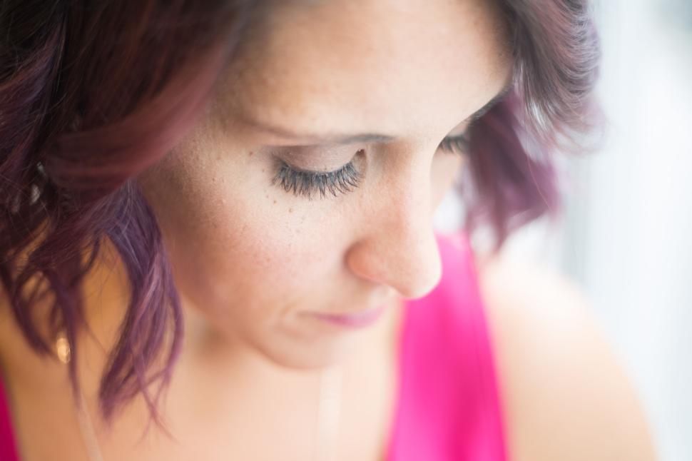 Free Image of Woman in bright pink top with short dark wavy hair, cropped view 