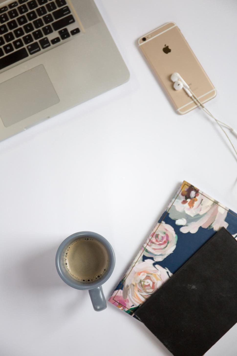 Free Image of Flat lay of work essentials laptop, coffee, phone, and journals 