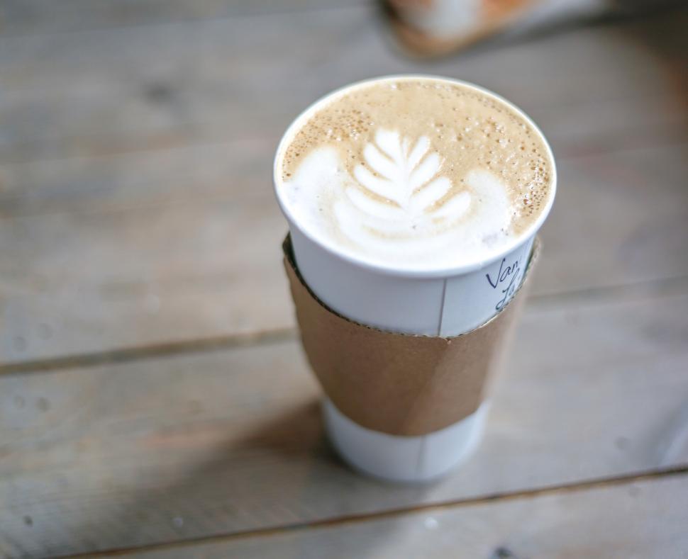 Free Image of Artisanal coffee with delicate latte art on wooden table 