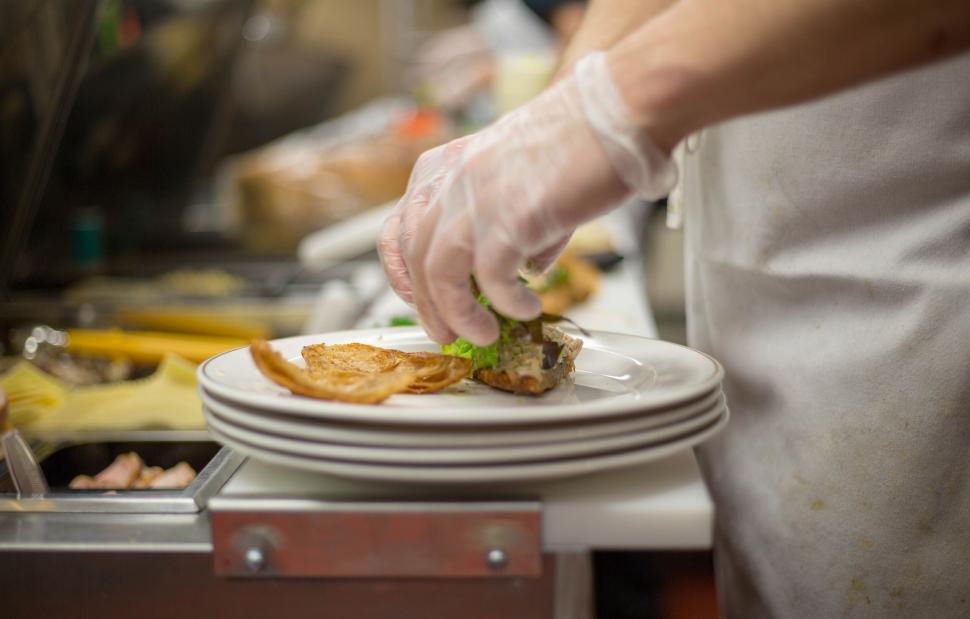Free Image of Chef preparing dish with gloves in commercial kitchen 