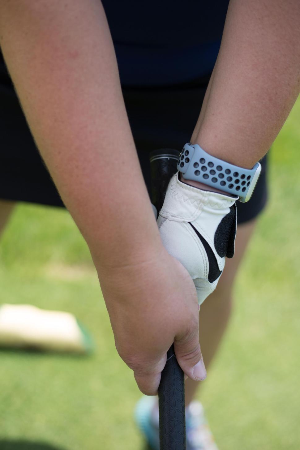 Free Image of Close-up of golfer gripping club handle ready to take a swing 