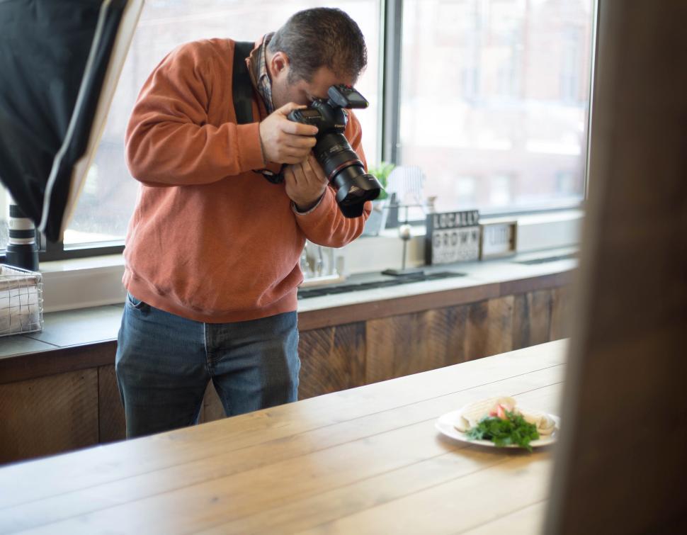 Free Image of Photographer capturing an image of food in a professional setup. 