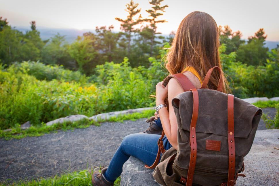 Free Image of Hiker with backpack enjoys scenic view in a natural setting 