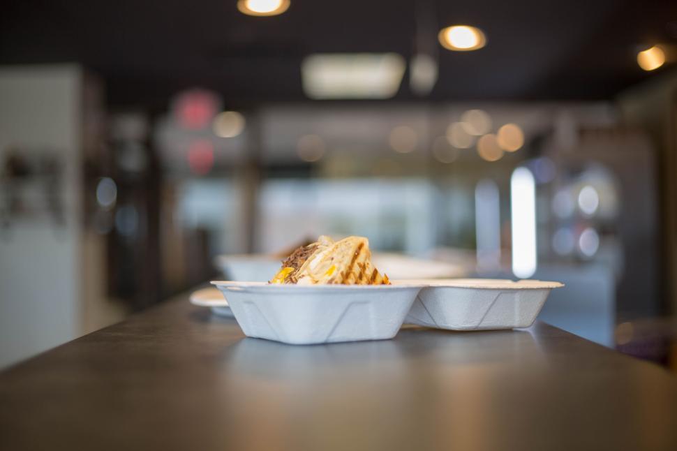 Free Image of Delicious meal served in plastic containers on a restaurant counter. 