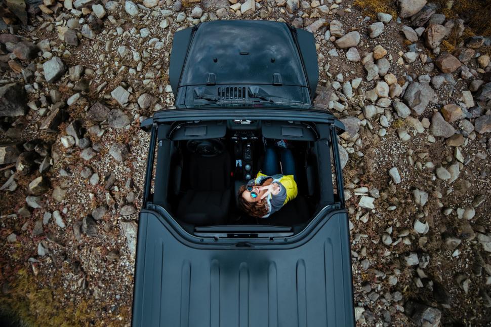 Free Image of Young woman enjoys a scenic off-road adventure in a Jeep 
