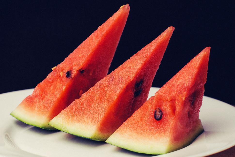 Free Image of Three fresh watermelon slices arranged neatly on a white plate 