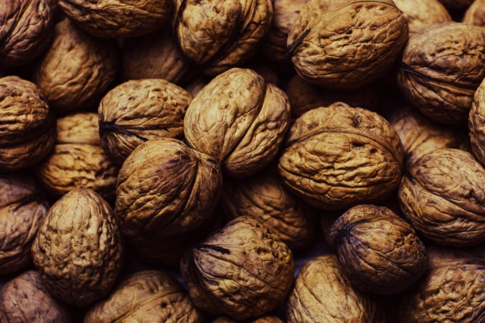 Free Image of Pile of walnuts in their shells showcasing natural brown textures 