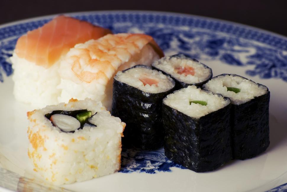 Free Image of Assorted sushi pieces arranged on a decorative plate for a meal. 