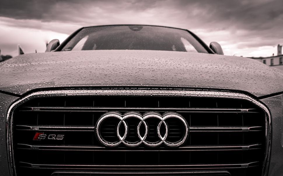 Free Image of Front view of luxury Audi S Q5 car with raindrops on the hood 