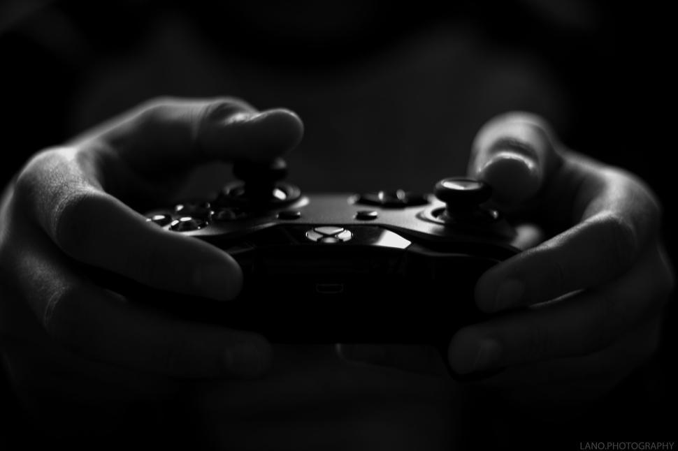Free Image of Close-up view of hands holding a video game controller in action 