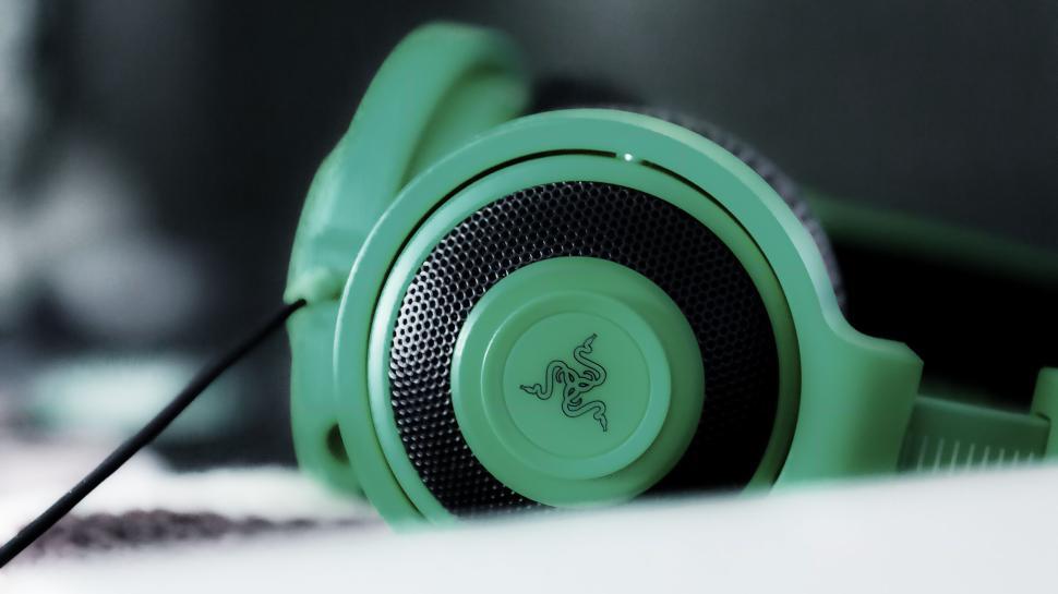 Free Image of Close-up of green and black gaming headphones with brand logo. 
