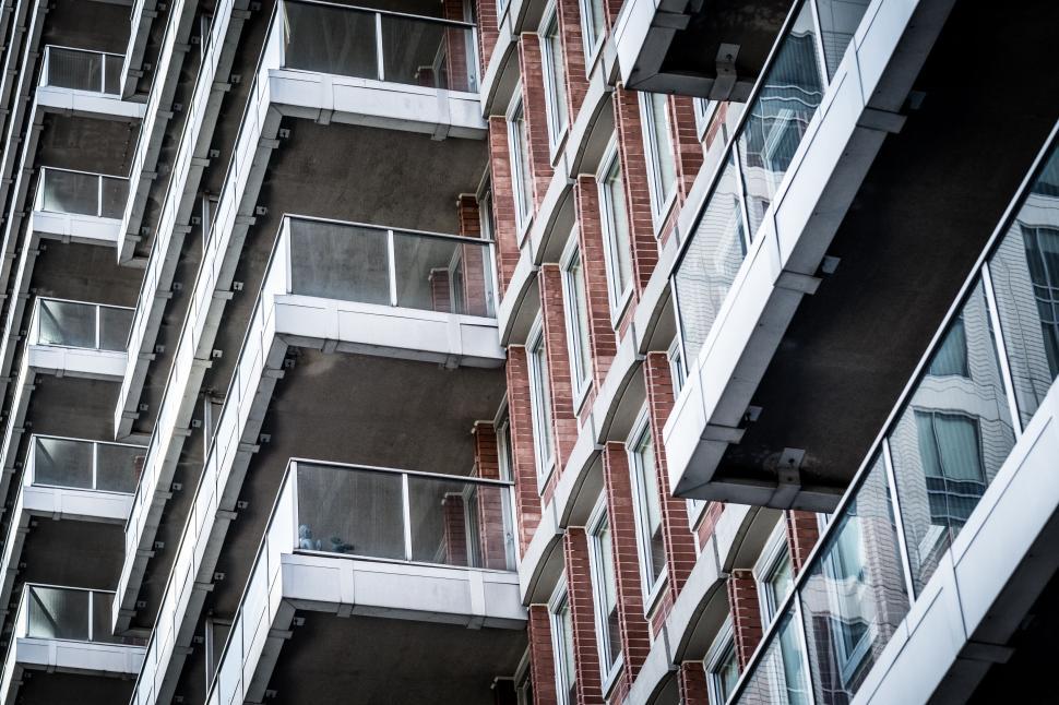 Free Image of Residential building with alternating balconies and brick exterior 