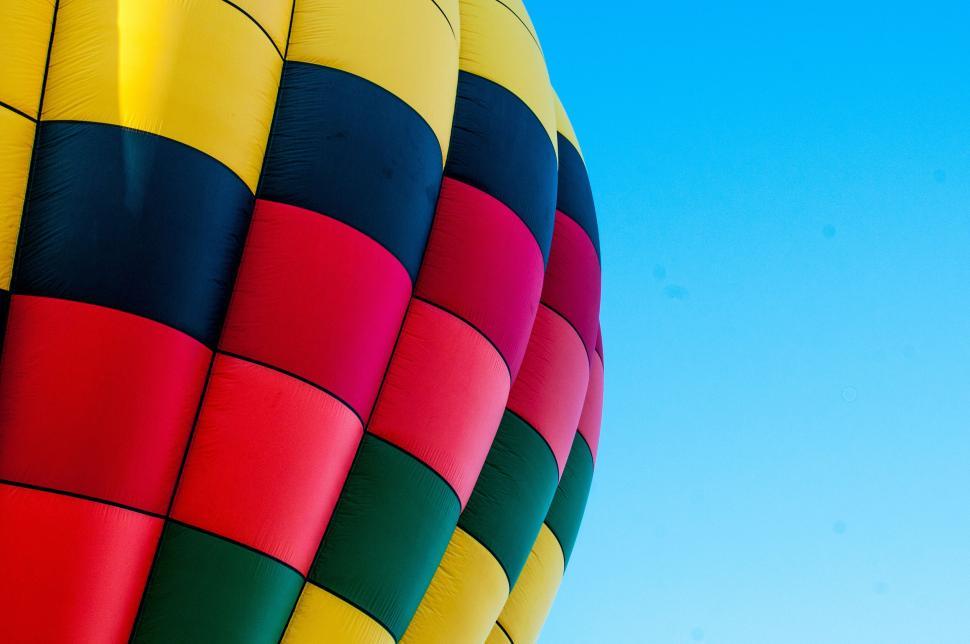 Free Image of Close-up view of vibrant hot air balloon ascending against clear sky 