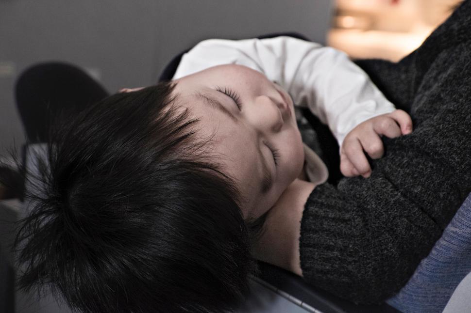 Free Image of Person resting with arm around them, creating a serene moment. 