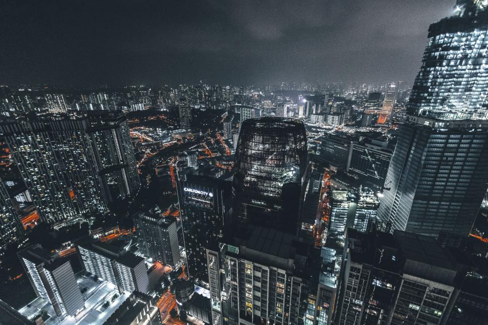 Free Image of Cityscape at night with glowing lights showcasing tall buildings. 