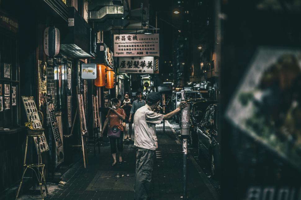 Free Image of Night street scene in an asian city with people and neon signs. 