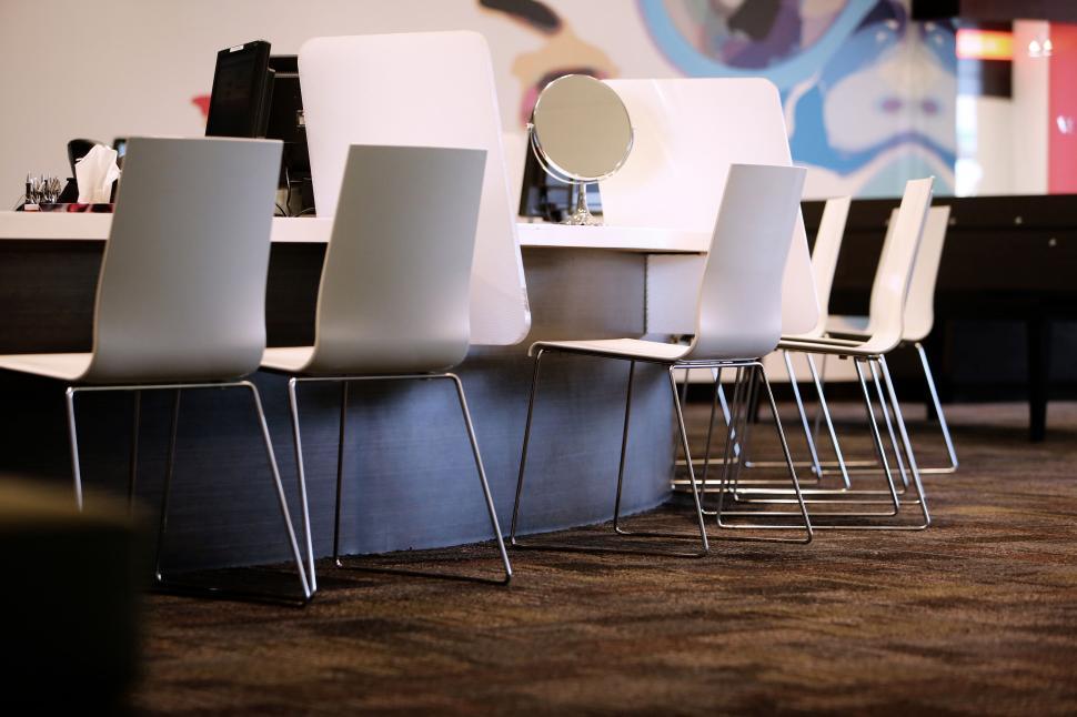 Free Image of Modern office workspace with white chairs perfectly aligned 