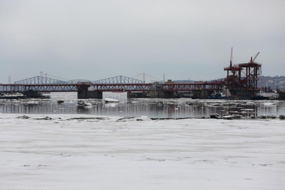 Free Image of Bridge under construction over a partially frozen river 