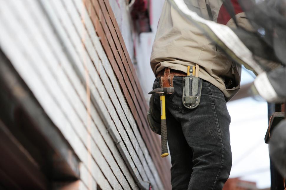 Free Image of Close-up of worker s tool belt with hammer at construction site 