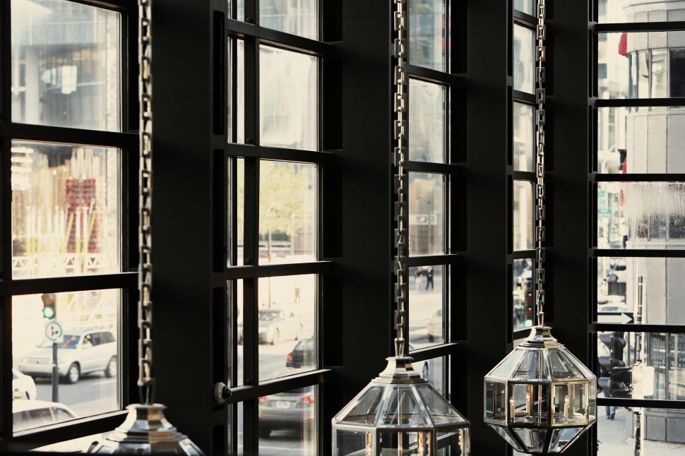 Free Image of Interior architectural design with hanging glass lamps and windows 