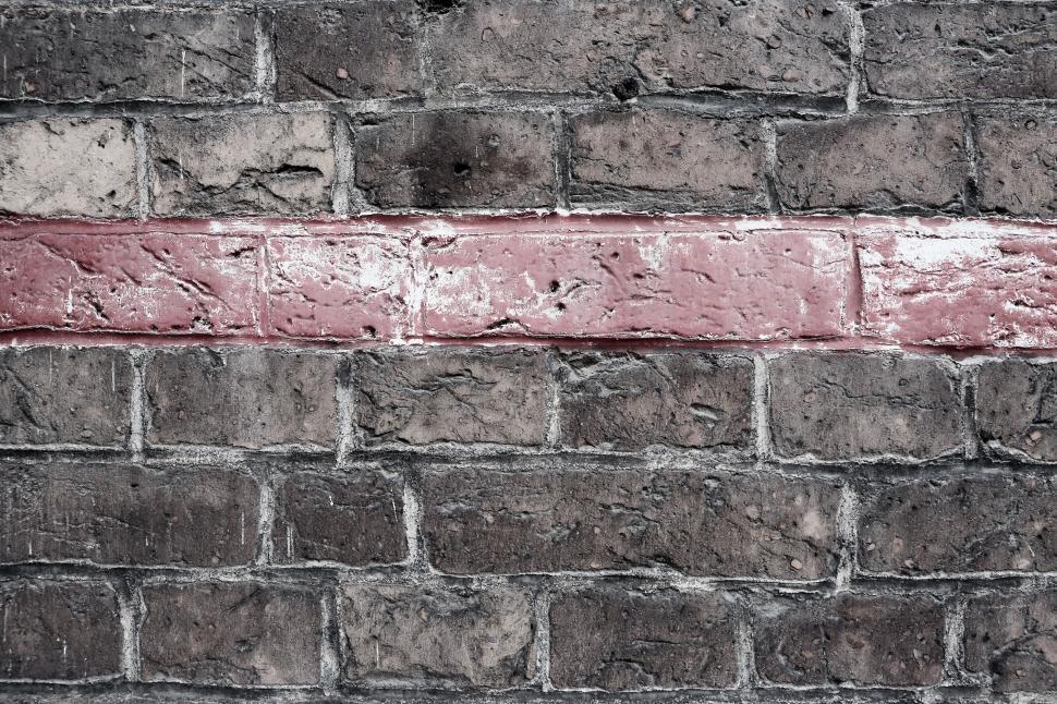 Free Image of Old brick wall with a single horizontal red brick strip detail 