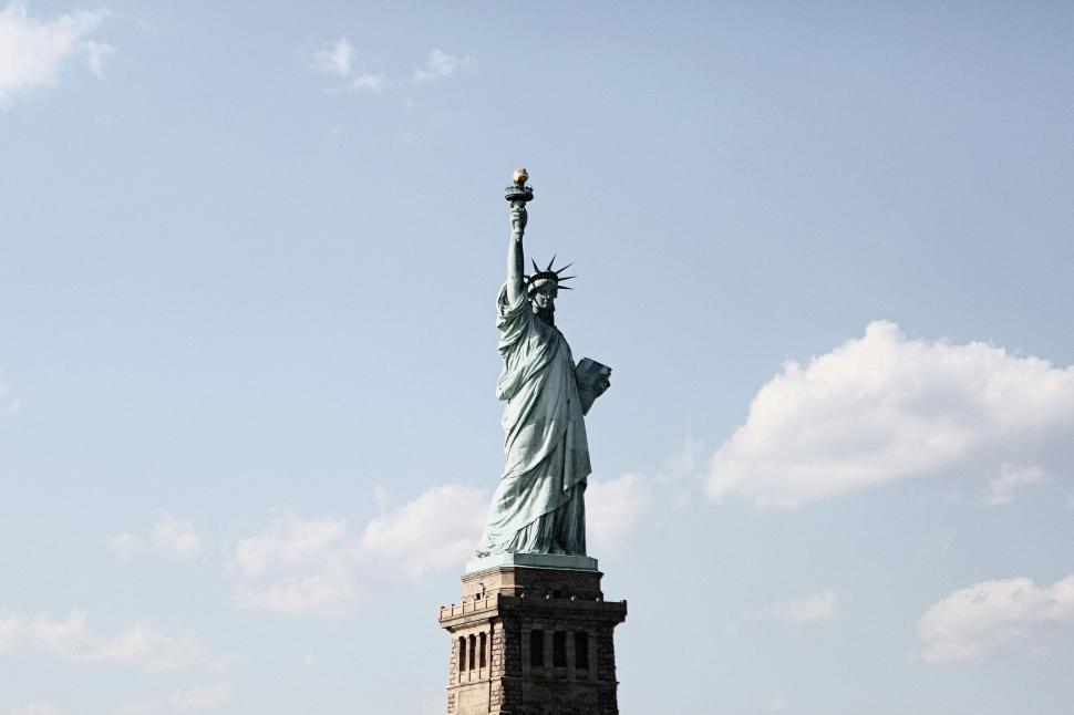 Free Image of Statue of Liberty standing tall under bright blue sky in New York 