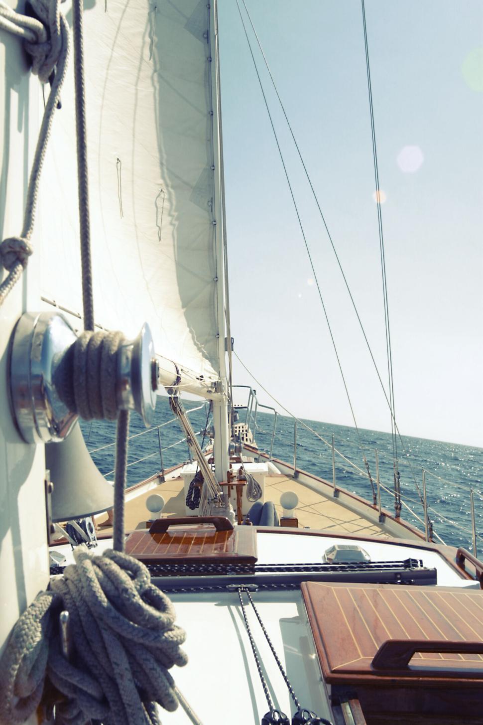 Free Image of Sailing on a boat with sails up on a sunny day in the open sea 