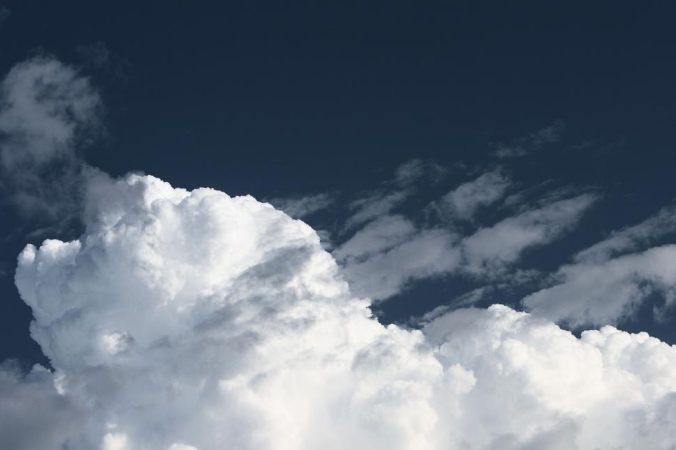 Free Image of Blue sky filled with large white fluffy cumulus clouds 
