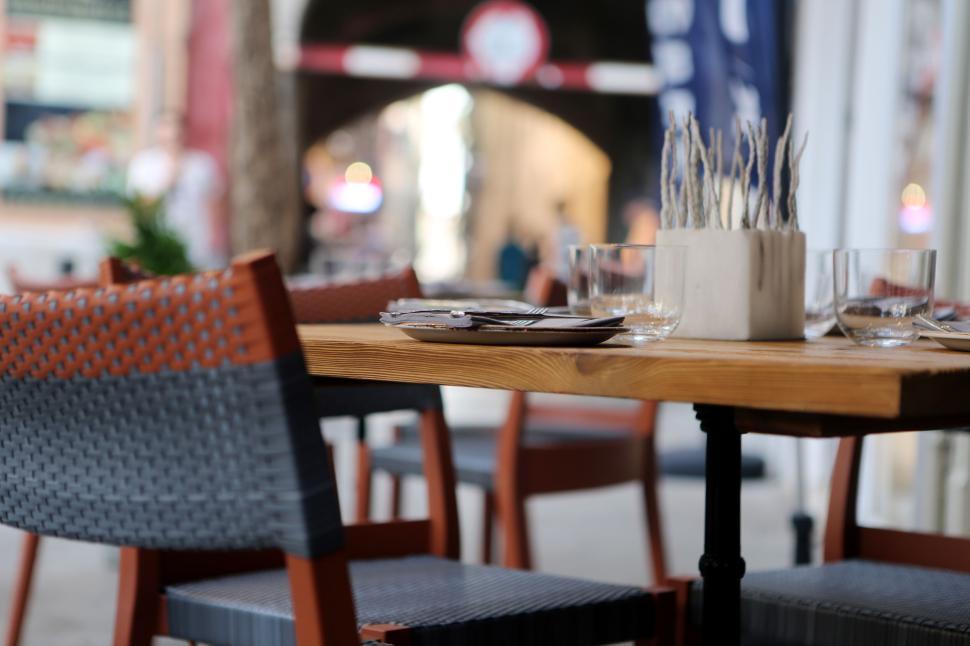 Free Image of Elegant outdoor dining setup with focus on table and chairs arrangement 