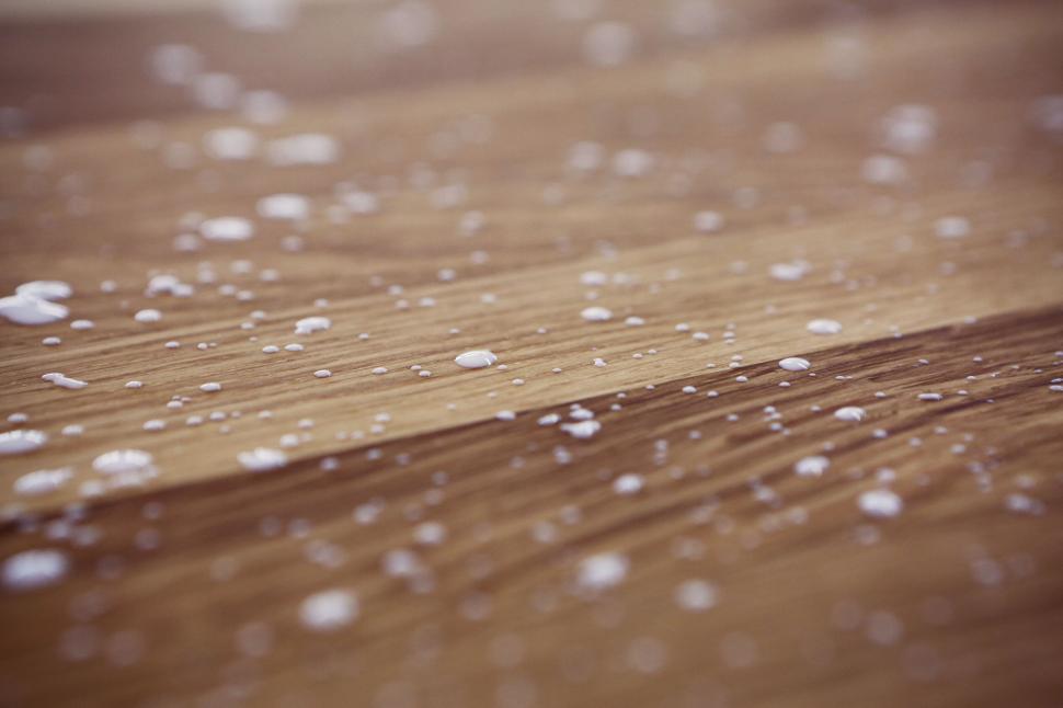 Free Image of Wooden Surface with Water Droplets Scattered Across its Surface 