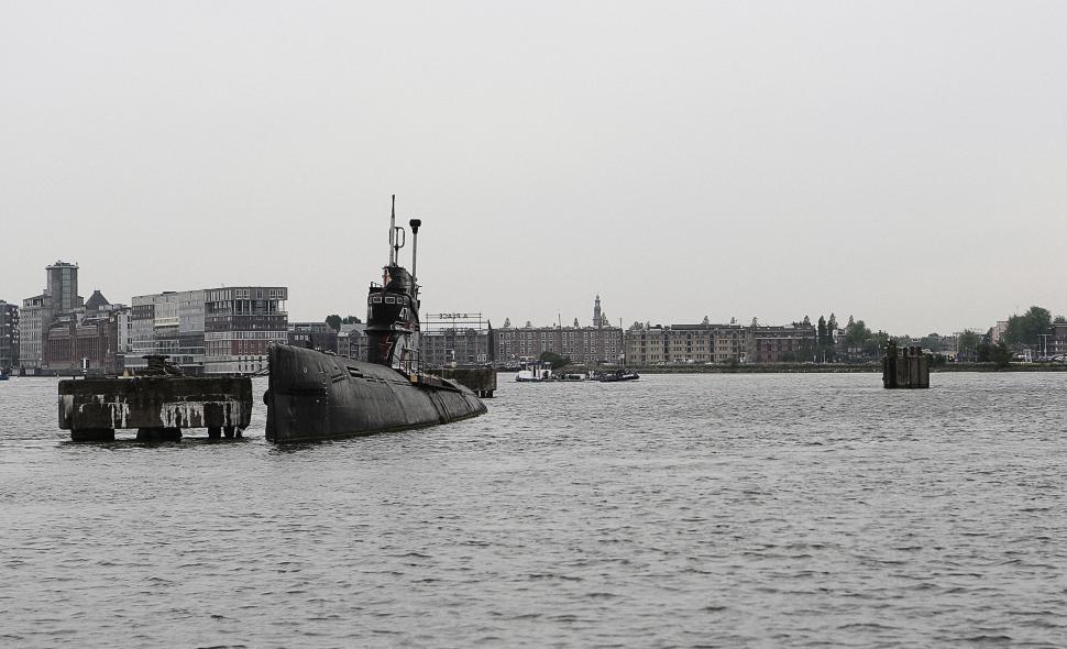 Free Image of Submarine Moored in a River Near the City on a Cloudy Day 