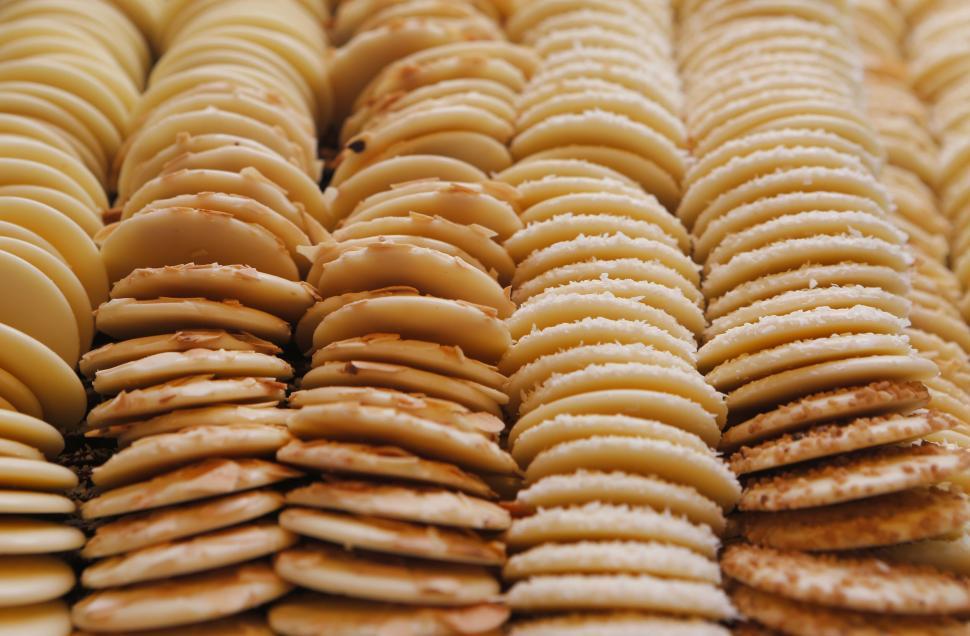 Free Image of Stacks of golden crackers arranged in neat rows for sale at a market. 