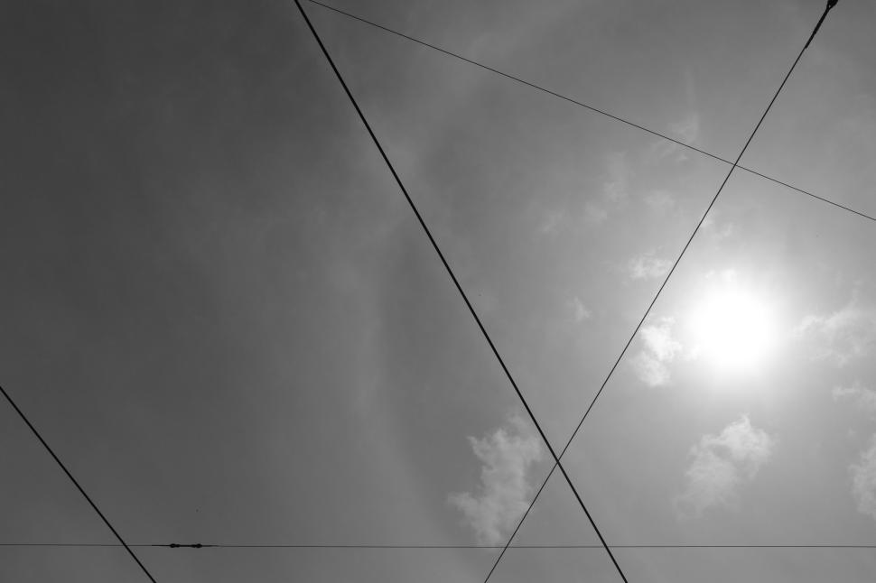 Free Image of Abstract black and white image of intersecting lines against the sky. 