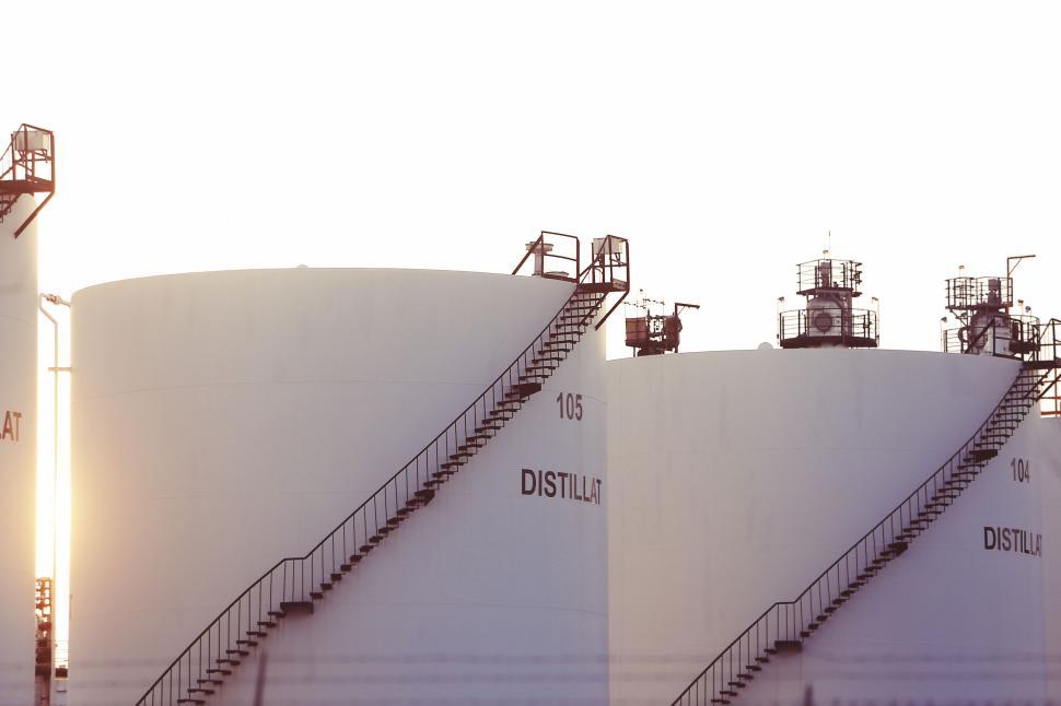 Free Image of Large distillation tanks with spiral staircases at a refinery site 