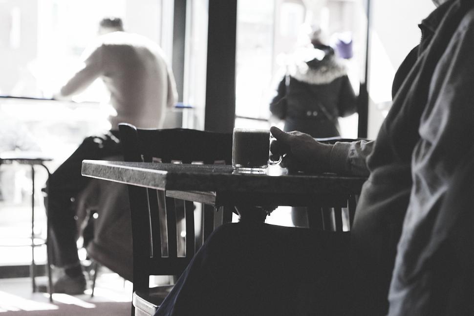 Free Image of A cozy cafe scene with people enjoying their coffee and time. 