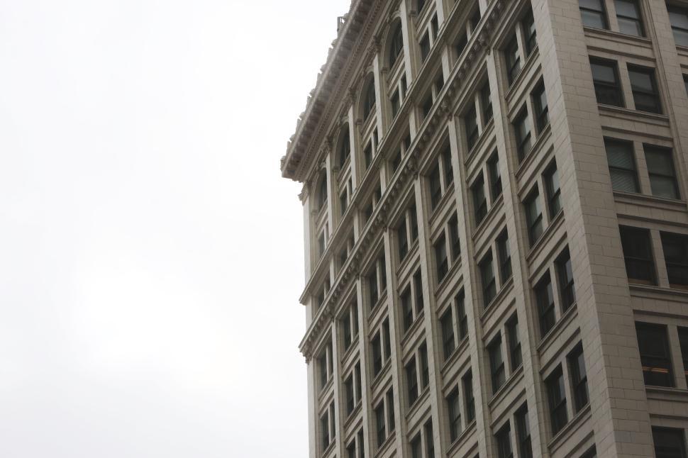 Free Image of A low angle view of a historic multi-story building downtown. 
