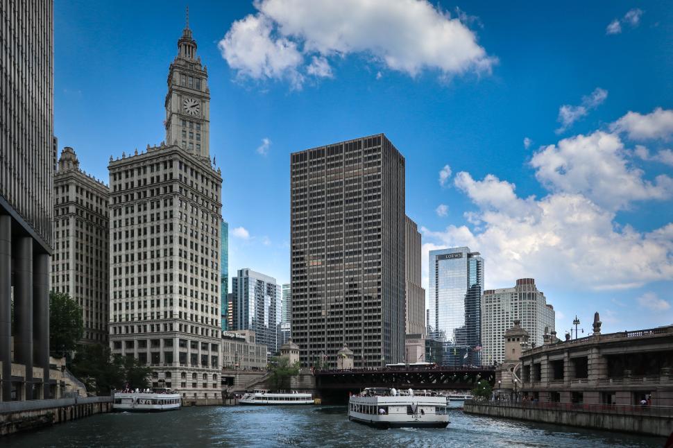 Free Image of Boats on the river with a backdrop of Chicago s skyscrapers. 