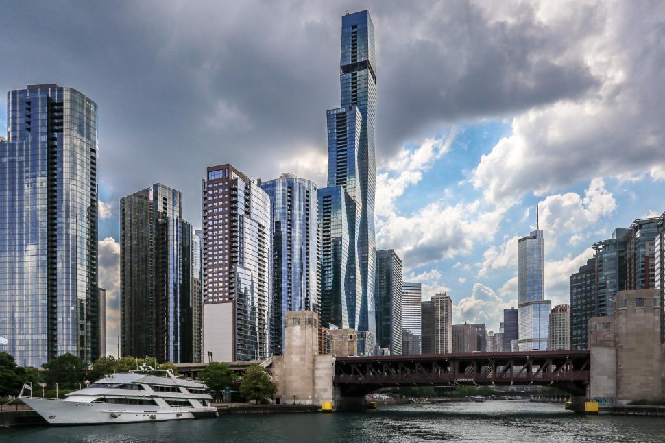 Free Image of Futuristic Skyscraper Cluster Along Chicago River with Dramatic Sky 