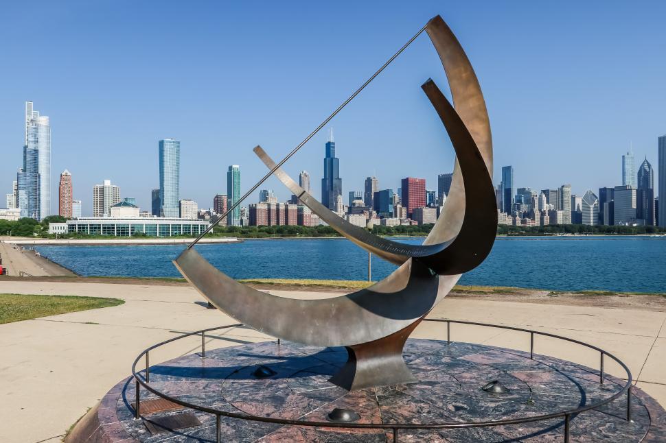 Free Image of Man Enters the Cosmos Sculpture by Henry Moore with Chicago skyline in background 