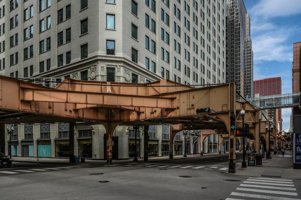 Free Image of Urban intersection beneath elevated train tracks in Chicago 