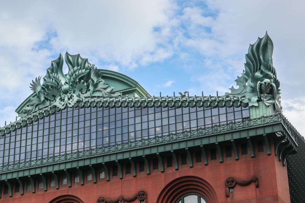 Free Image of Ornate statues adorn the top of the Harold Washington Library rooftop 