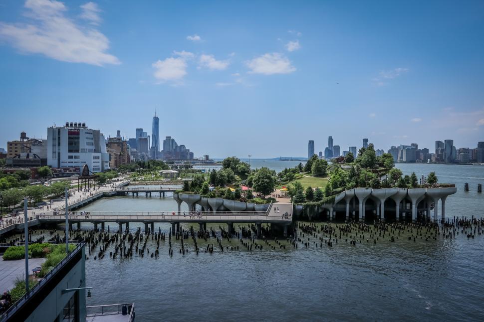Free Image of View of Little Island park structure over water with lower Manhattan in the distance. 