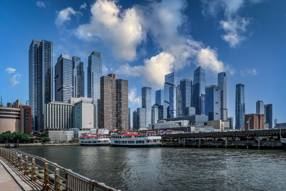 Free Image of New York City cityscape with skyscrapers and waterfront, daytime scene, blue sky. 
