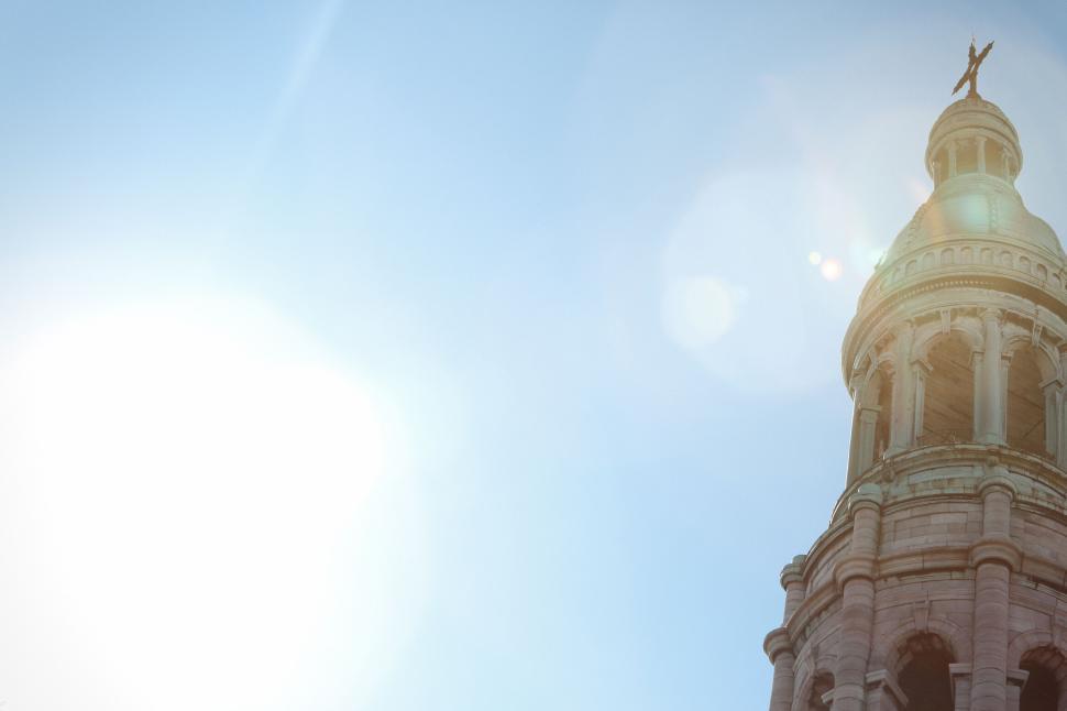 Free Image of Tower with a Cross on Top against a Bright and Clear Sky Background. 