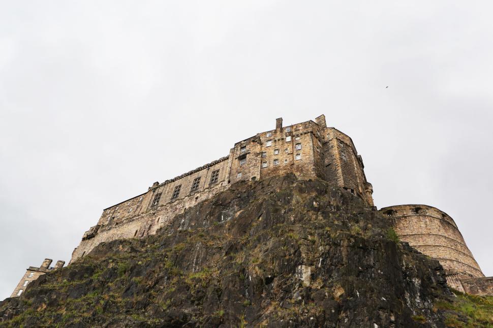 Free Image of Historic fortress built atop rocky cliff under an overcast sky 