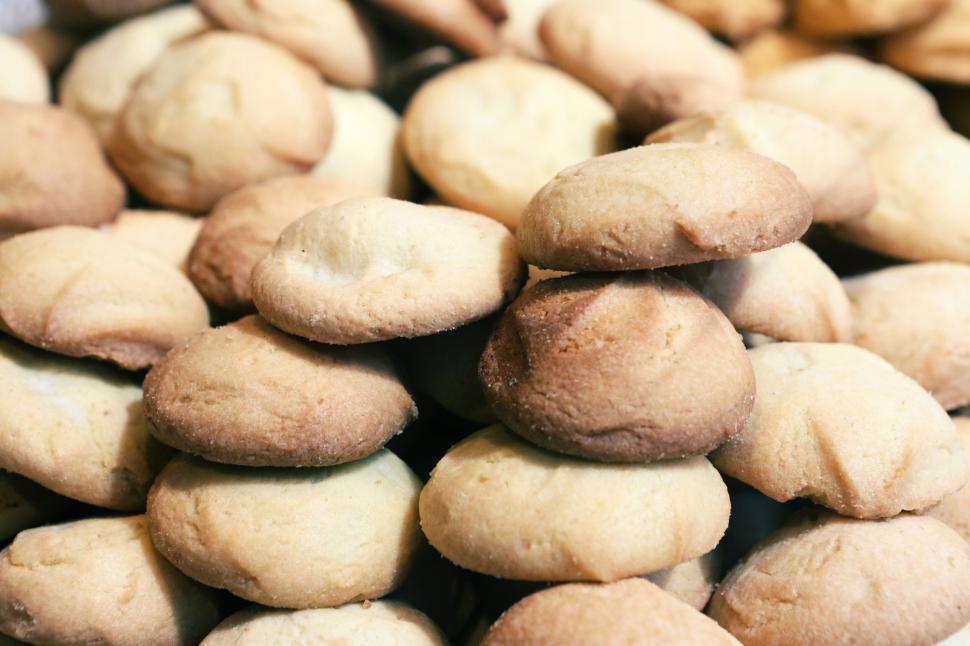 Free Image of Stack of freshly baked cookies with golden brown delightful crust 