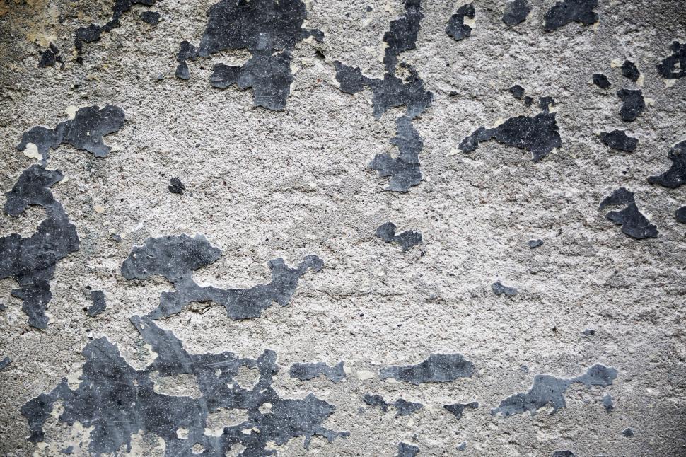 Free Image of Peeling paint on a weathered wall creating a rough textured pattern. 