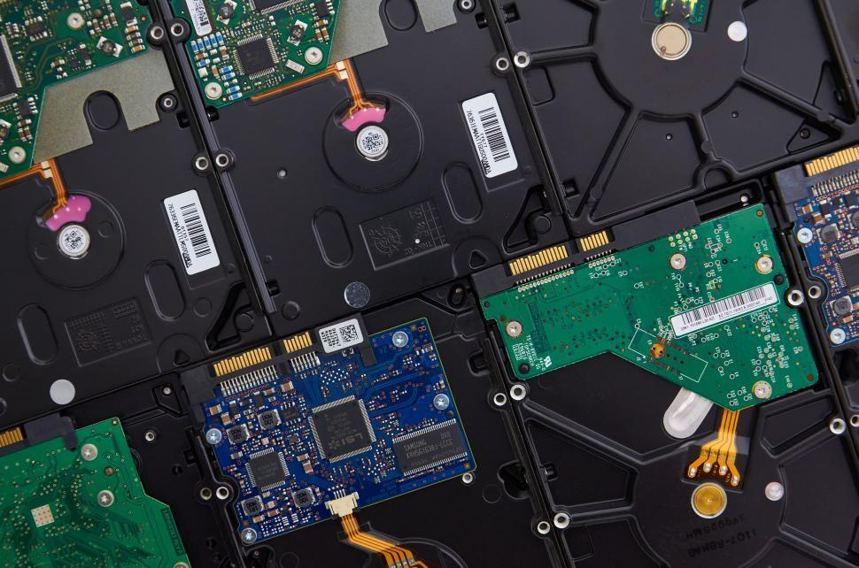 Free Image of Array of hard drives with various colored circuit boards on display 